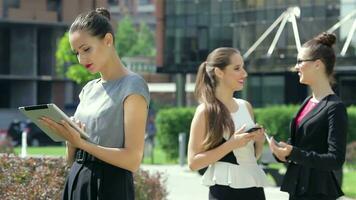 Business woman reads the news on the background of their business partners video