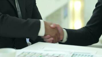 Successful businessmen sitting at table in office while discussing their business doings video