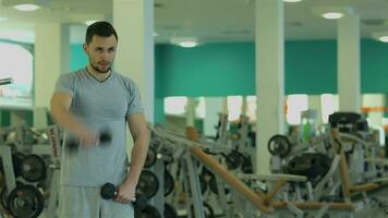 Young man doing exercise with dumbbells for triceps and then meets coach video