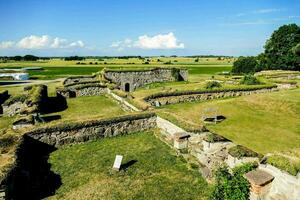 the ruins of an old castle in the middle of a field photo