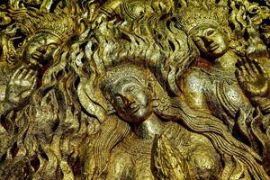 golden statues of the buddha and other gods photo