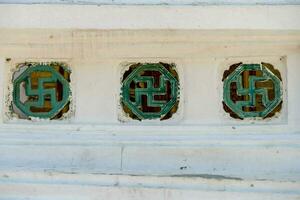 three green and white tiles on a wall photo