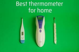 Text BEST Thermometer for home. Three different types of thermometers on green background. mercury, infrared contactless Thermometer. Choosing thermometer for house photo