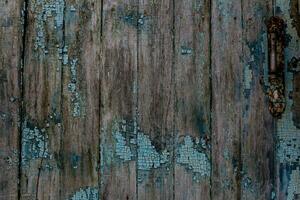 Wooden background of the old wooden planks with remnants of blue paint. Natural texture of painted wood. photo