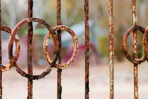 A rusty fence at an abandoned resort on the beach. A fence of iron rods photo