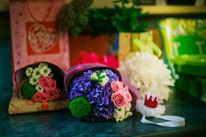 A bouquet for the birthday of a little girl of pink roses, a blu photo