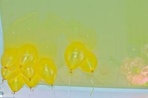 Yellow balls on the ceiling. Registration of children's holidays. Decoration of the hall with balls. photo