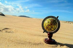 a globe in the desert photo