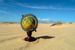 a globe in the desert photo