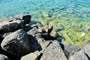 rocks and clear water in the ocean photo