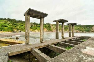 old wooden pier at the beach photo