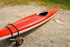 a red and white kayak on a trailer photo