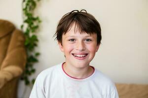 Handsome teen boy while spending time alone at home, sharing in social media, teen lifestyle photo