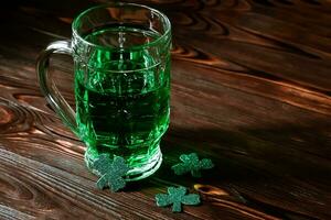 Green lucky clover. Party on Patrick's Day. A holiday tradition and a festive glass of green fir in an Irish pub. photo
