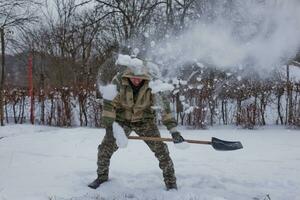 man clears the yard of snow With Shovel. Heavy snowfall in winter. High level of snow. Snowy snowdrift. photo