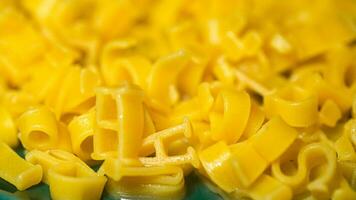 macaroni alphabet letters on a green plate. photo