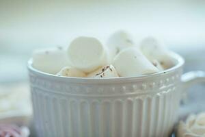 Grey beautiful cup with marshmallow sprinkled with grated chocolate. photo