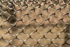 Mesh rabitz , texture of weaving mesh network link. Close up of a fence. barrier on way. metal grid close-up. rusty mesh texture photo