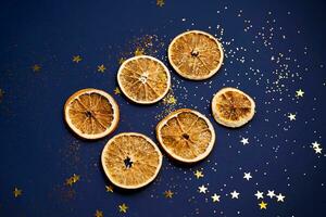 Dried orange slices on a blue background with stars. photo