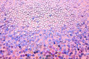 Purple sparkles on a pink background. photo