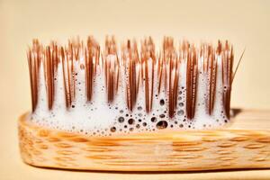 Toothbrush with toothpaste foam close-up. photo