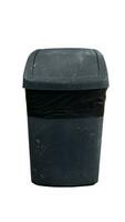 Background and textured of old black plastic trash bin with a black garbage bag lining. Container with a lid that can be rotated. with clipping path. photo
