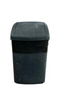 Background and textured of old black plastic trash bin with a black garbage bag lining. Container with a lid that can be rotated. with clipping path. photo