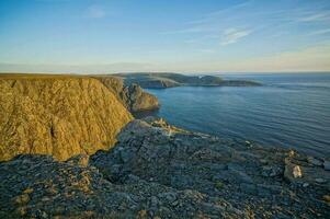 the view from the top of a cliff overlooking the ocean photo