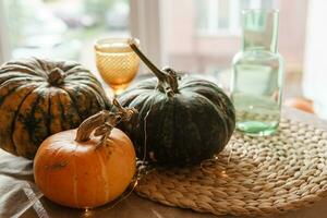 Autumn interior. a table covered with dishes, pumpkins, a relaxed composition of Japanese pampas grass. Interior in the photo Studio. Close - up of a decorated autumn table.