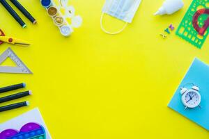 Close up of stationery and silicone toy popit. Flat lay composition. Yellow background. Space for text. Back to school photo