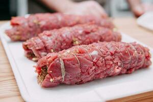 Cooking meat rolls in a cooking class. The beef roll. Raw meat, close-up. photo