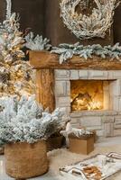 The interior of a room with a fireplace, Christmas trees with artificial snow and garlands, a blanket and a tray with hot drinks. The magical atmosphere of Christmas. photo