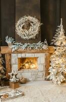 The interior of a room with a fireplace, Christmas trees with artificial snow and garlands, a blanket and a tray with hot drinks. The magical atmosphere of Christmas. photo
