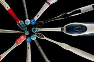 a group of different toothbrushes arranged in a circle photo