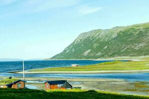 a small village on the shore of the ocean photo