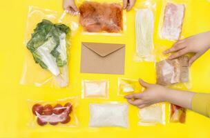 Salad dinner set. chicken, lettuce, tomatoes, peking cabbage, cheese, bacon, bread, olive oil sauces and spices. A set for delivering food for dinner on a yellow background. I cook at home. photo