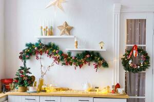 Kitchen interior decorated for Christmas and New Year. New Year's interior in red and white tones. photo