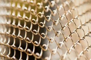 Mesh rabitz , texture of weaving mesh network link. Close up of a fence. barrier on way. metal grid close-up. rusty mesh texture photo