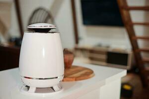 White Humidifier against the background of modern chalet-style apartment. photo