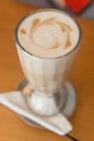 Latte in a glass glass, Breakfast in a cafe. photo