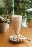 Latte in a glass glass, Breakfast in a cafe. photo