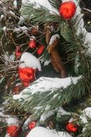 Christmas trees decorated with red balloons in front of the cafe entrance. Street Christmas decorations. photo