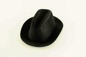 a black hat on a white surface photo