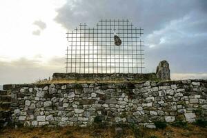 a metal fence with a bird on it photo