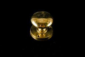 a brass knob on a black background photo