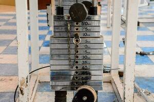 a stack of weights on a rack in a gym photo