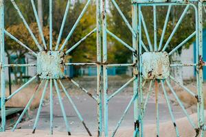 A rusty fence at an abandoned resort on the beach. Fence with a photo