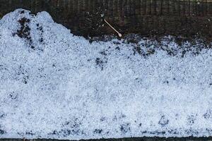 Snow-covered old plank outdoors in winter photo