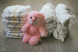 stack of clean and bunch of twisted rolls to reduce volume of disposable diapers. photo