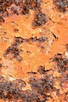 rusty metal surface with orange paint photo